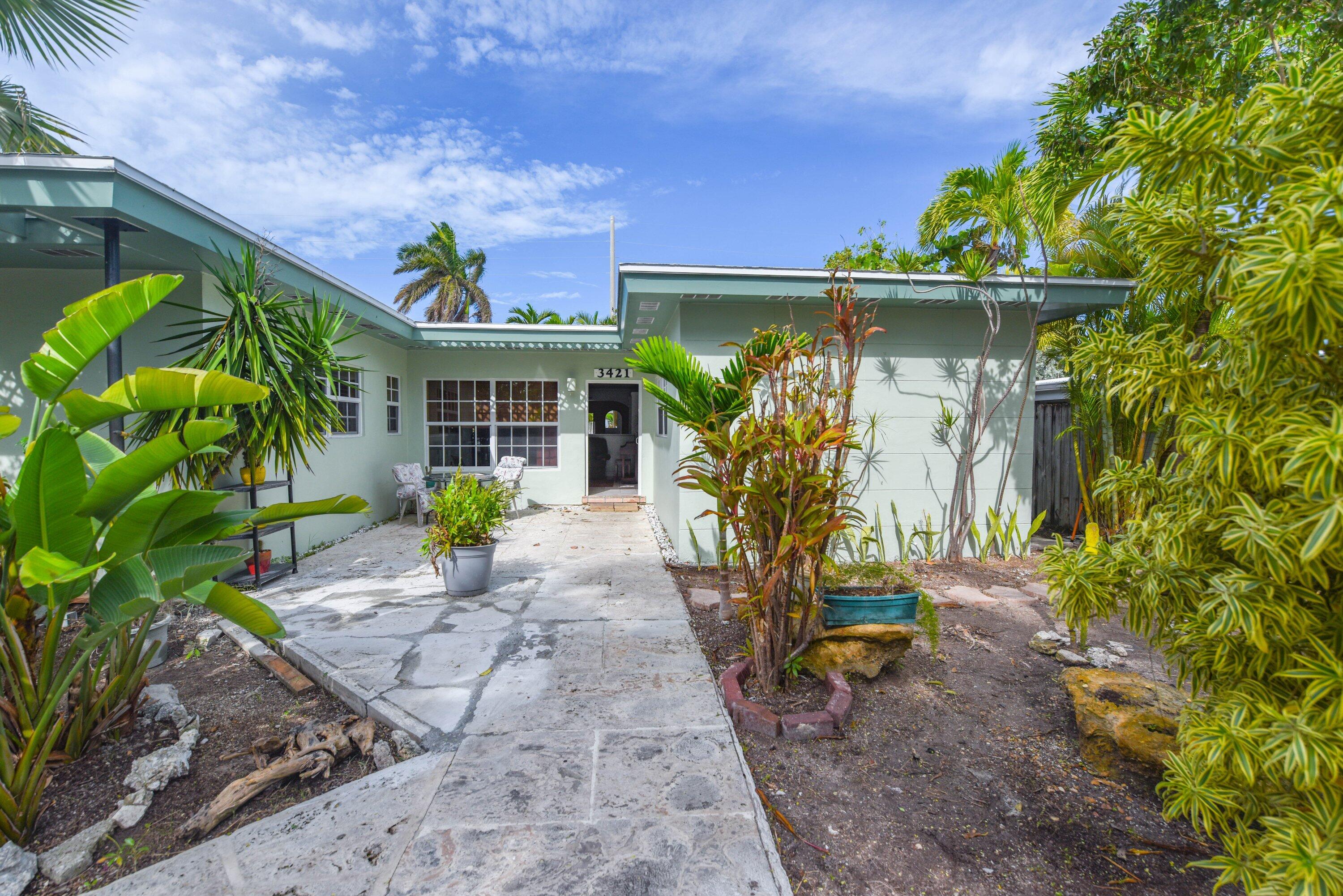 3421 Riviera Drive Key West, FL 33040 - Photo 4 of 32 a front view of house with a garden