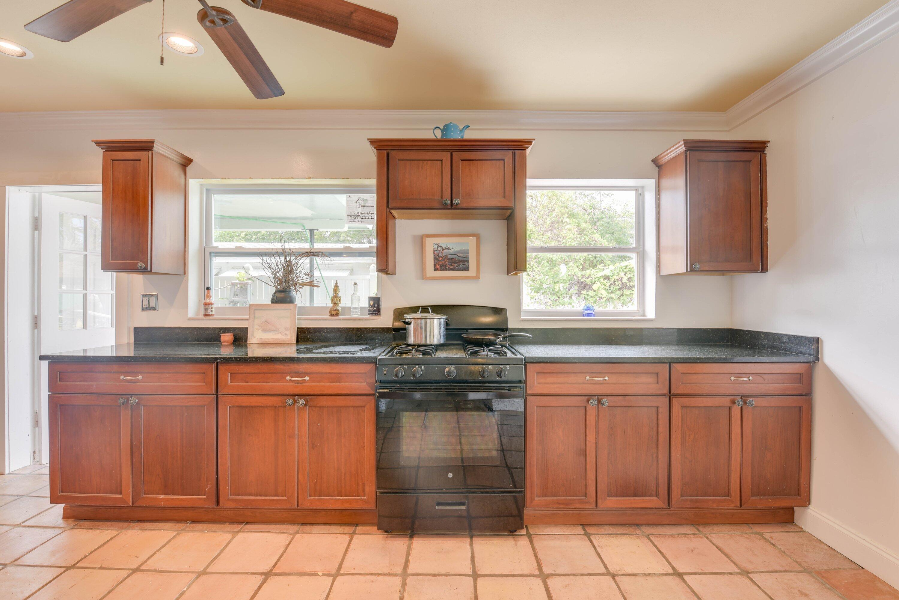 3421 Riviera Drive Key West, FL 33040 - Photo 10 of 32 a kitchen with stainless steel appliances granite countertop a stove a sink and a microwave