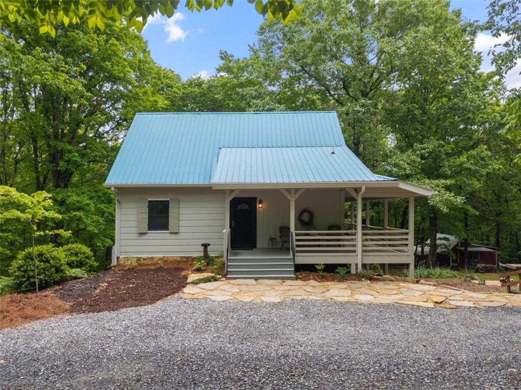 219 Raven Cliff Road Talking Rock, GA 30175 - Photo 4 of 77 a front view of a house with a yard