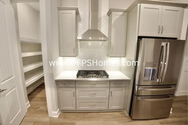 a kitchen with granite countertop a stove and a refrigerator