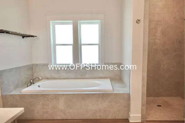 a bathroom with a bathtub and shower
