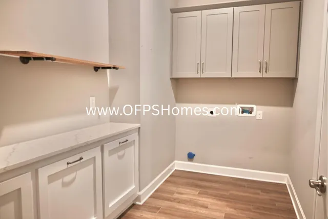 a view of a kitchen with white cabinets