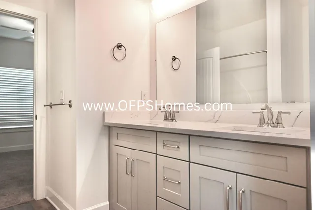 a bathroom with a sink vanity and a mirror