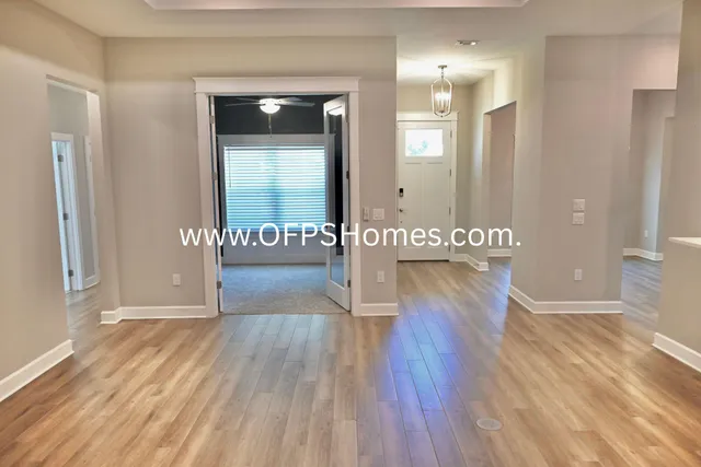 a view of a hallway with wooden floor