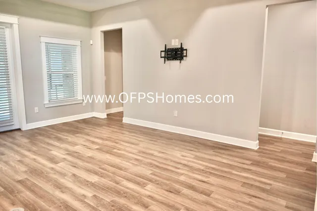 a view of a room with wooden floor and windows