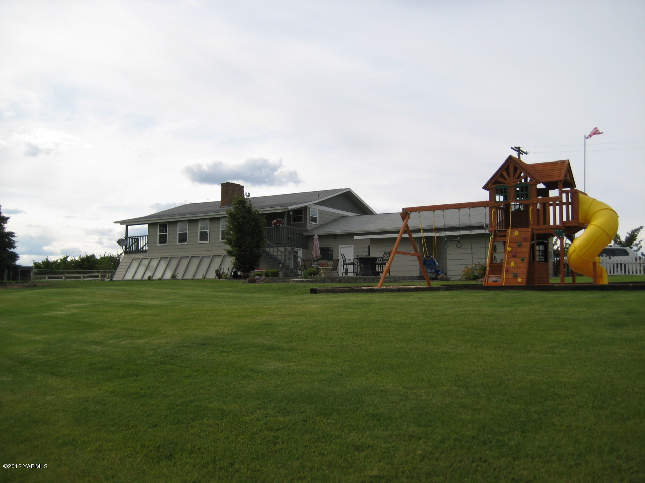 a front view of house with outdoor space and trees