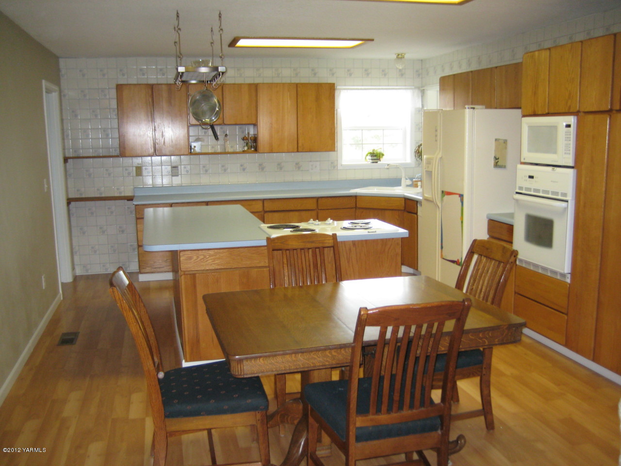 40 Elliott Road Cowiche, WA 98923 - Photo 3 of 24 a kitchen with stainless steel appliances granite countertop a dining table chairs and a refrigerator