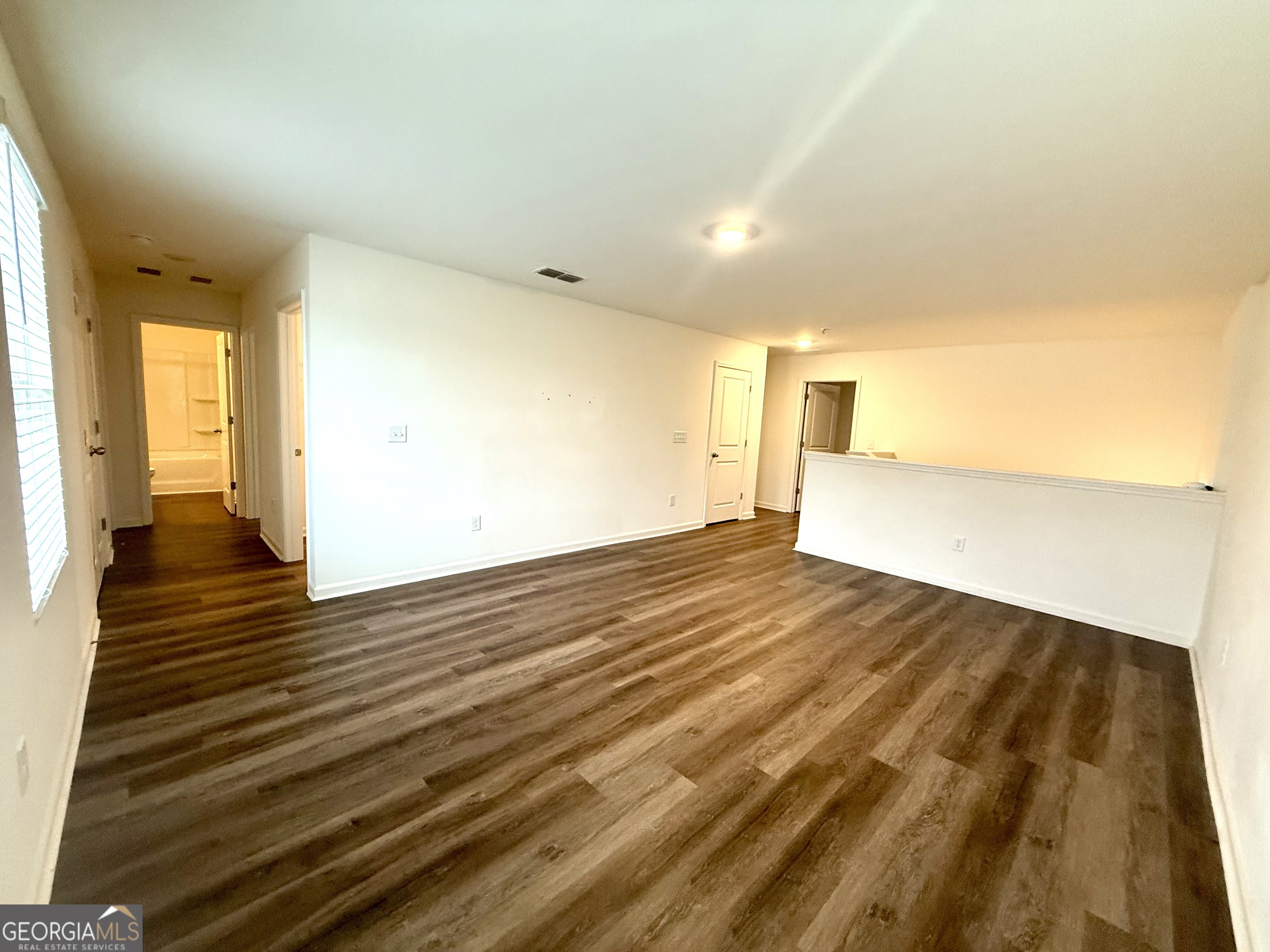119 Pond Court Hoschton, GA 30548 - Photo 12 of 29 a view of an empty room and wooden floor