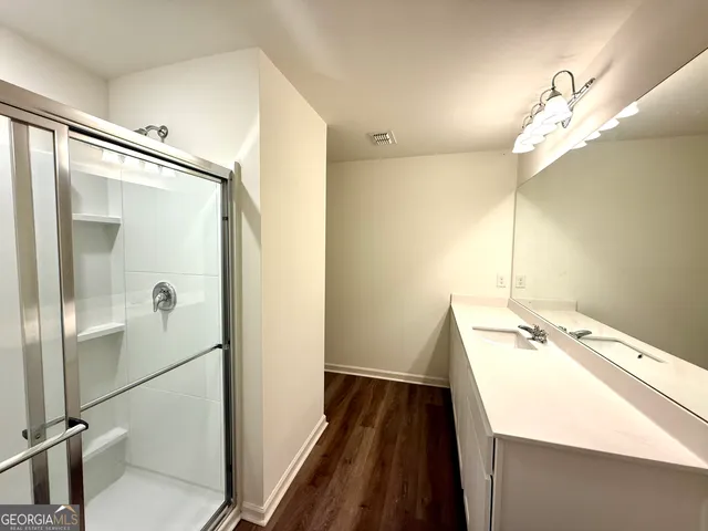 a bathroom with a sink a mirror and a shower