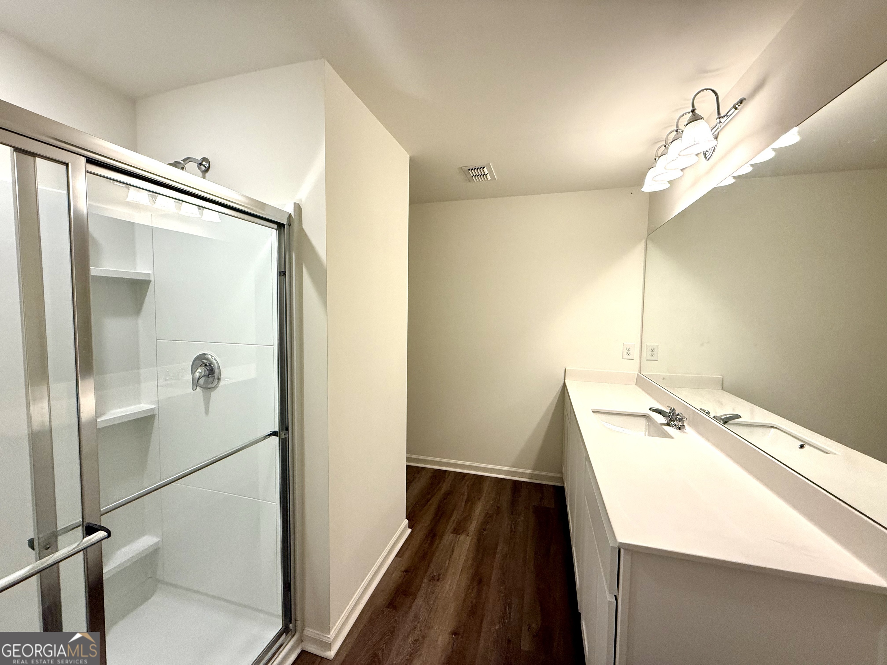 119 Pond Court Hoschton, GA 30548 - Photo 14 of 29 a bathroom with a sink a mirror and a shower