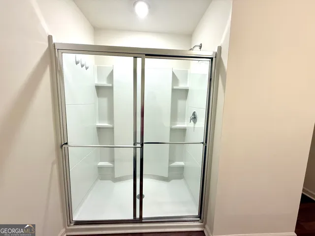 a bathroom with a glass shower door