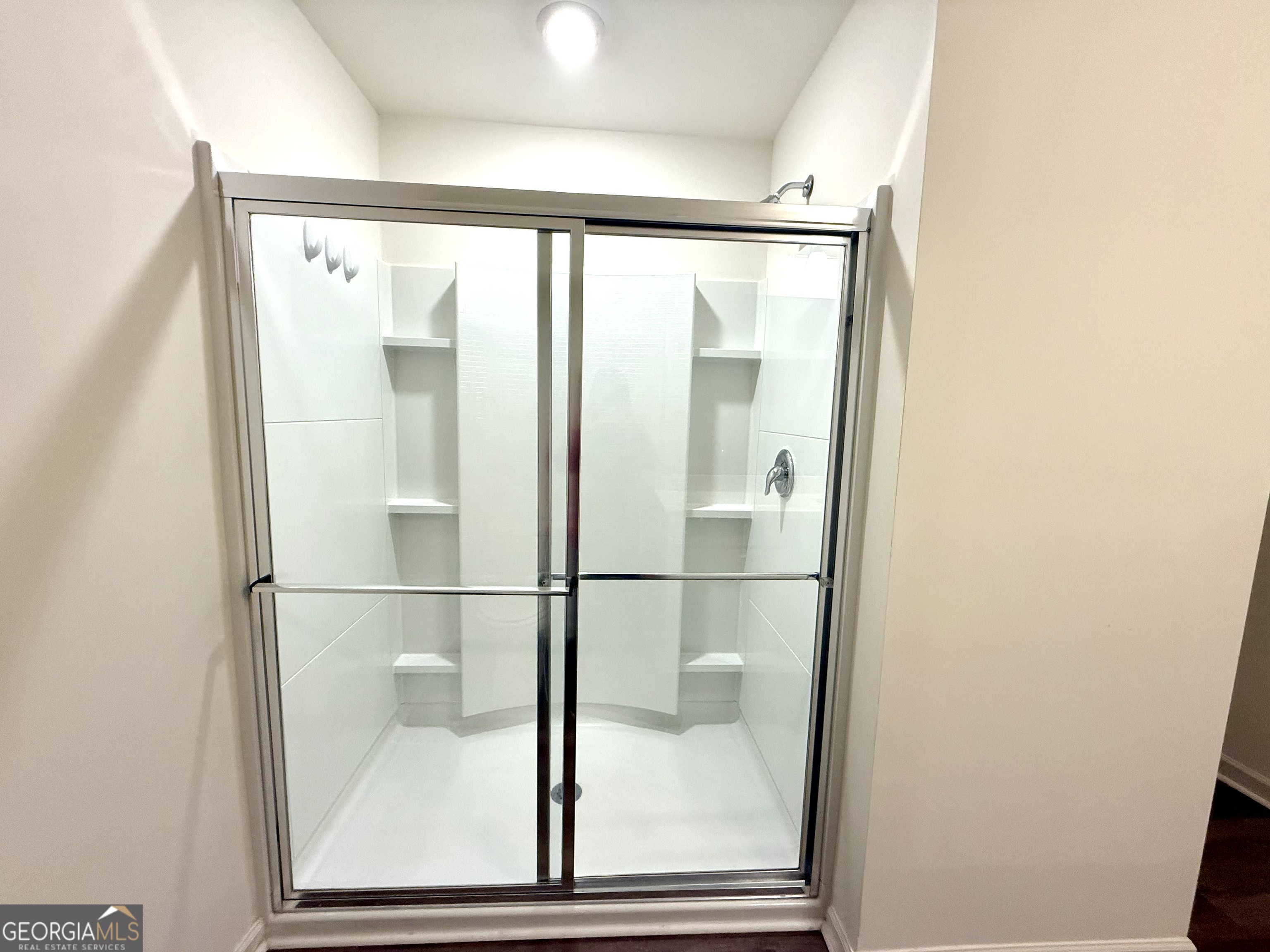 119 Pond Court Hoschton, GA 30548 - Photo 16 of 29 a bathroom with a glass shower door