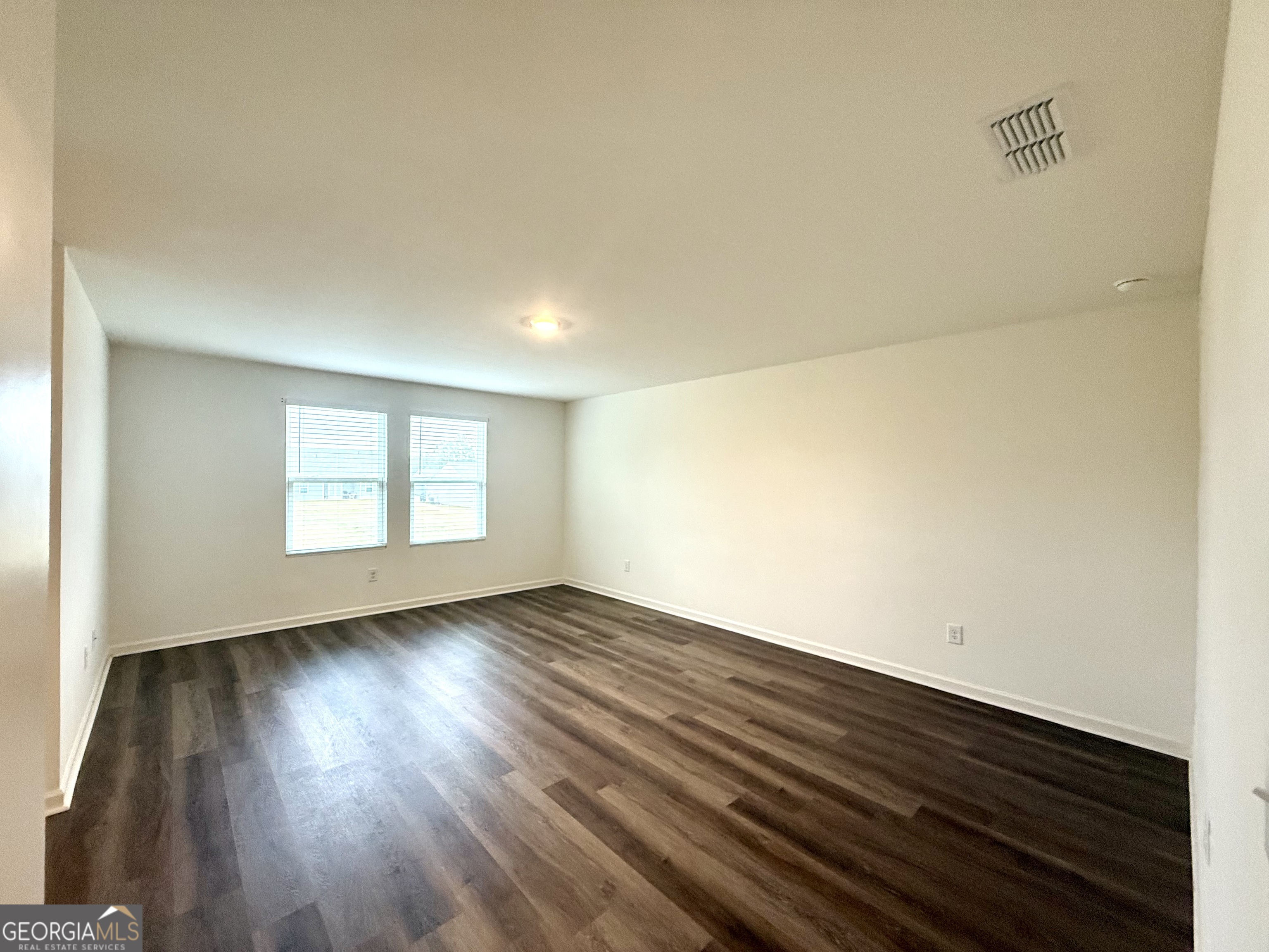 119 Pond Court Hoschton, GA 30548 - Photo 19 of 29 an empty room with wooden floor and windows