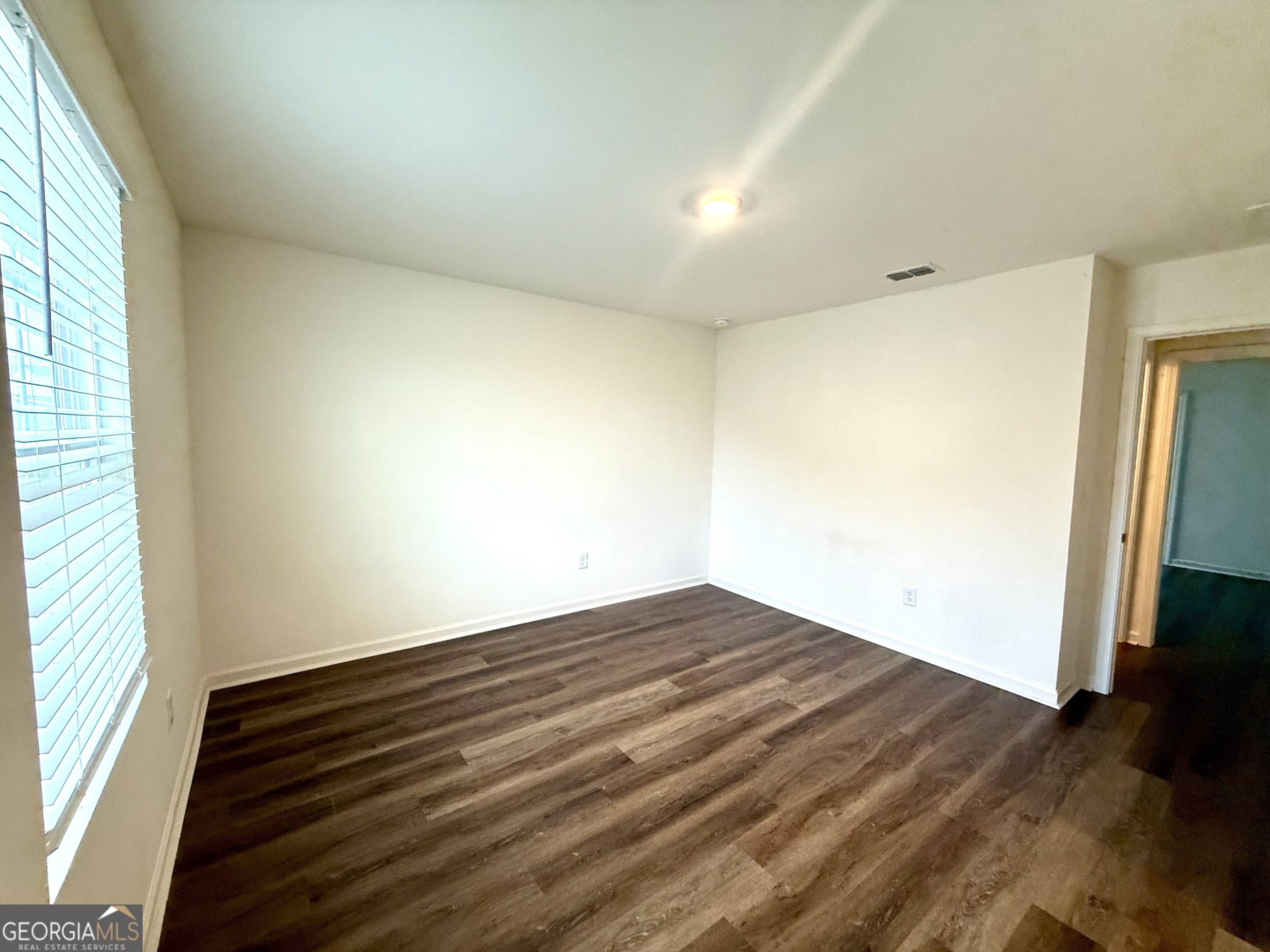 119 Pond Court Hoschton, GA 30548 - Photo 24 of 29 an empty room with wooden floor and windows