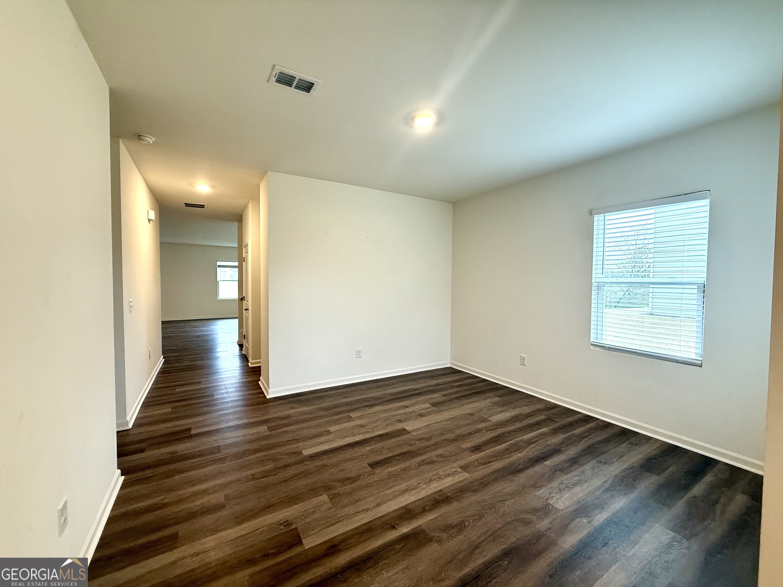 119 Pond Court Hoschton, GA 30548 - Photo 6 of 29 an empty room with wooden floor and windows