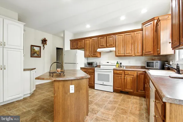 a kitchen with a stove top oven sink and cabinets