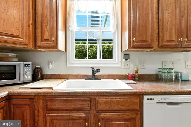 a kitchen with granite countertop a sink and a window