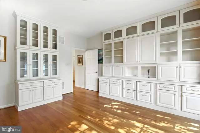 a view of a kitchen with cabinets and wooden floor