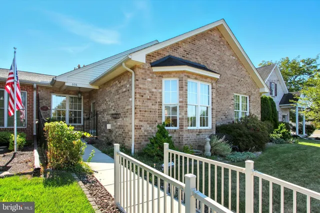 a view of a house with brick walls and flower plants