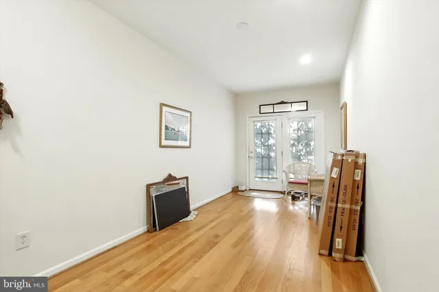 a view of a livingroom with wooden floor and a window