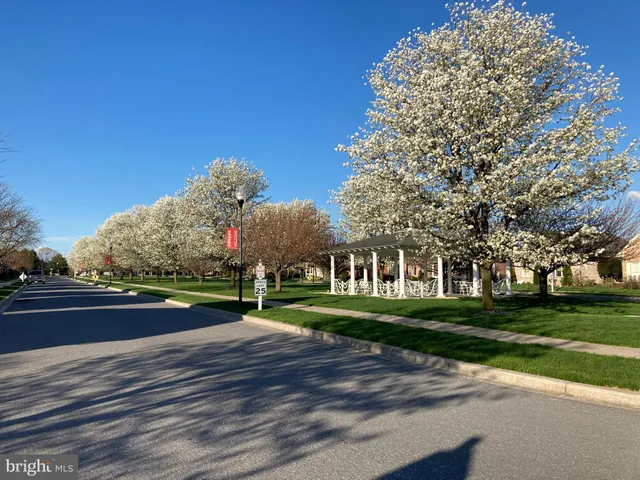 a street sign that is in front of flowers