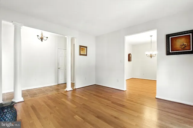 a view of empty room with wooden floor