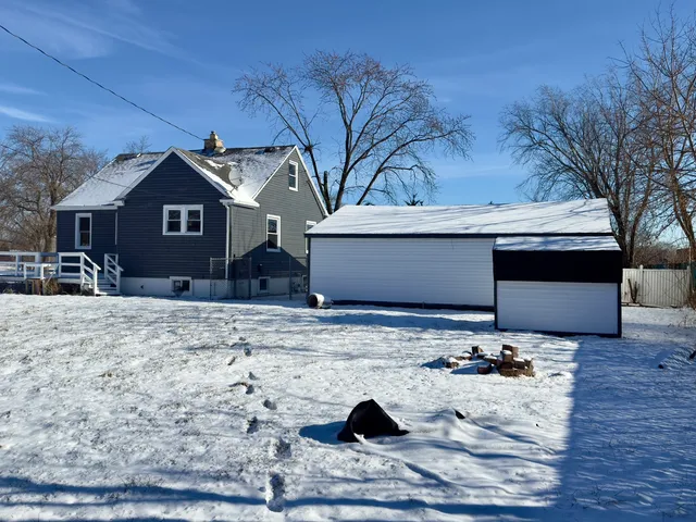 a view of a house with a snow in the yard