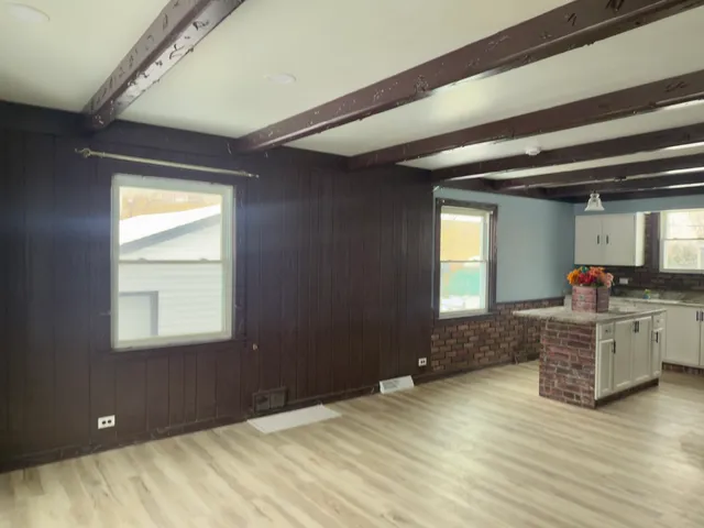 a kitchen with kitchen island granite countertop a stove a sink and a window