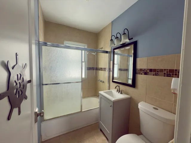 a bathroom with a toilet sink and a shower