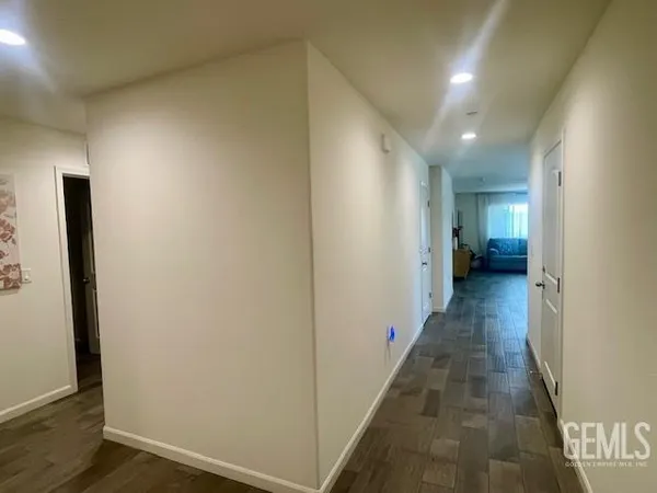 an entryway of a house and an empty room