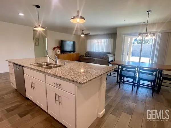 a kitchen with granite countertop sink microwave and dining table