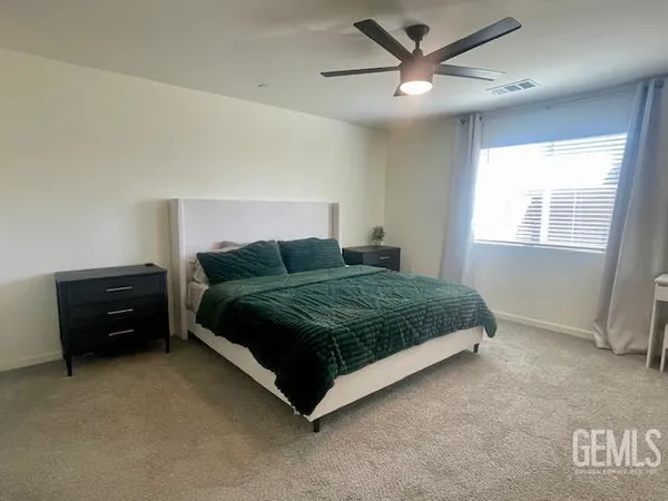 a bedroom with a bed and window