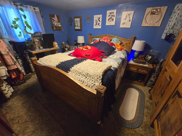 a bed sitting in a bedroom next to a window