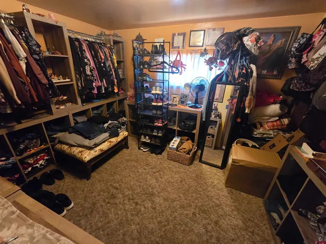 a view of a living room with clothes and shoes