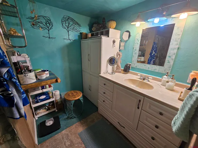 a bathroom with a sink mirror and toilet