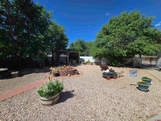 a view of a backyard with sitting area