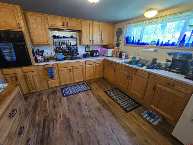a kitchen with lots of counter top space and wooden floor