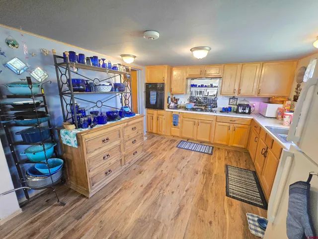 a kitchen with stainless steel appliances a stove a sink dishwasher and a refrigerator