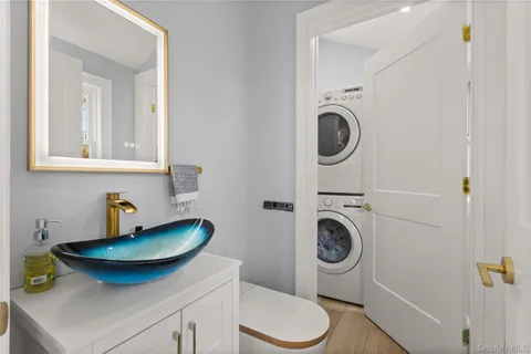 a bathroom with a sink a toilet and a mirror