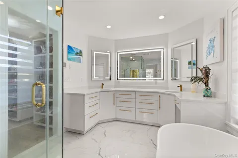 a spacious bathroom with a granite countertop sink a toilet a mirror and shower