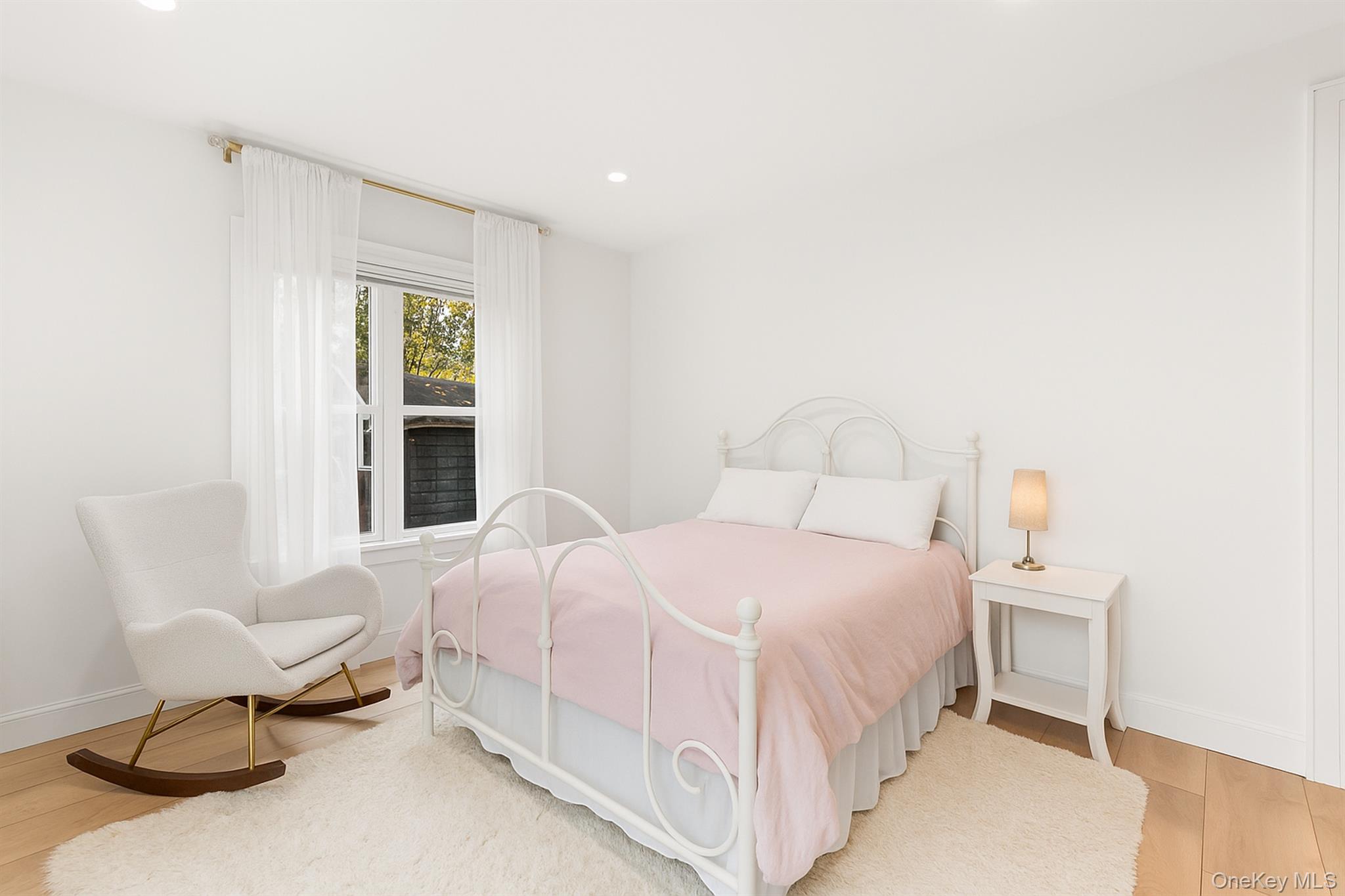 272 Ocean Avenue Islip, NY 11751 - Photo 22 of 39 a bedroom with a bed and chair