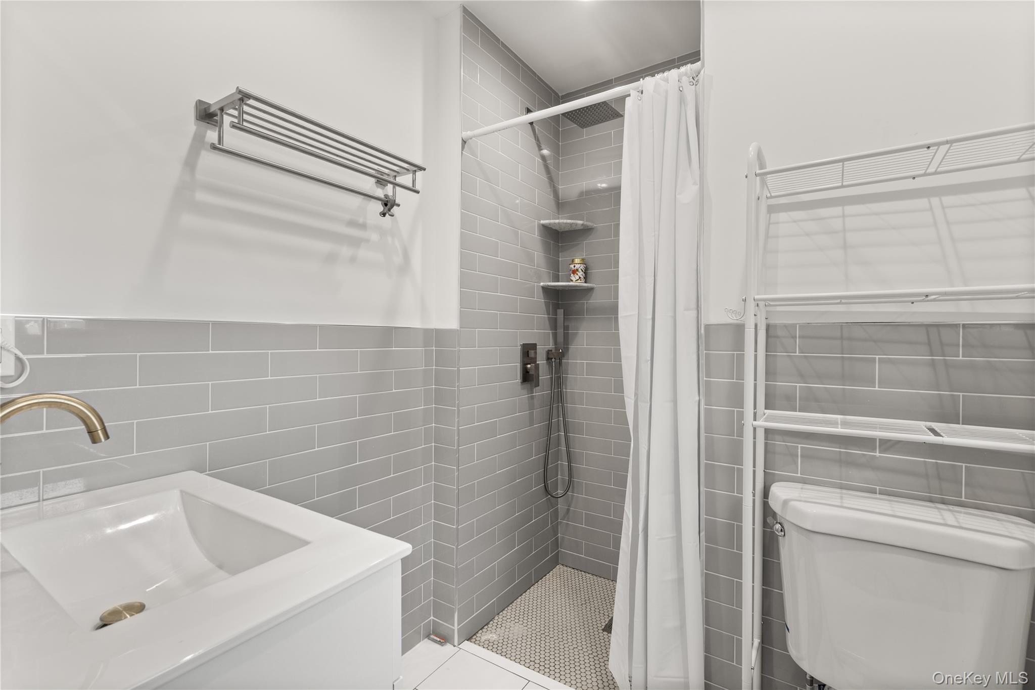 272 Ocean Avenue Islip, NY 11751 - Photo 23 of 39 a bathroom with a sink a toilet and shower