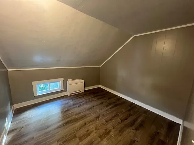 a view of a room with wooden floor and white walls