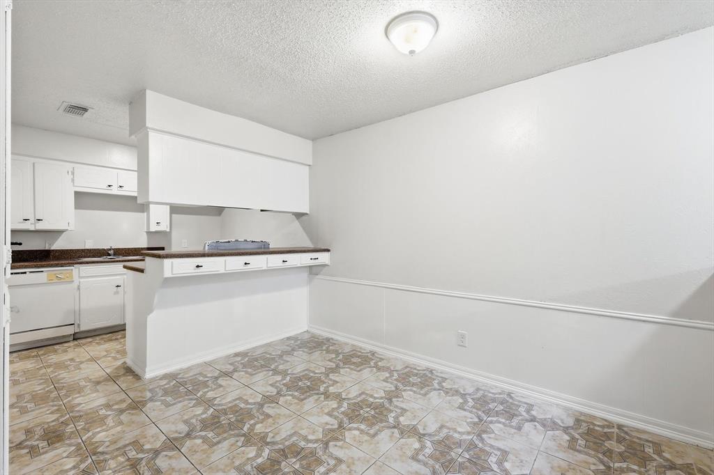 a view of kitchen with white cabinets