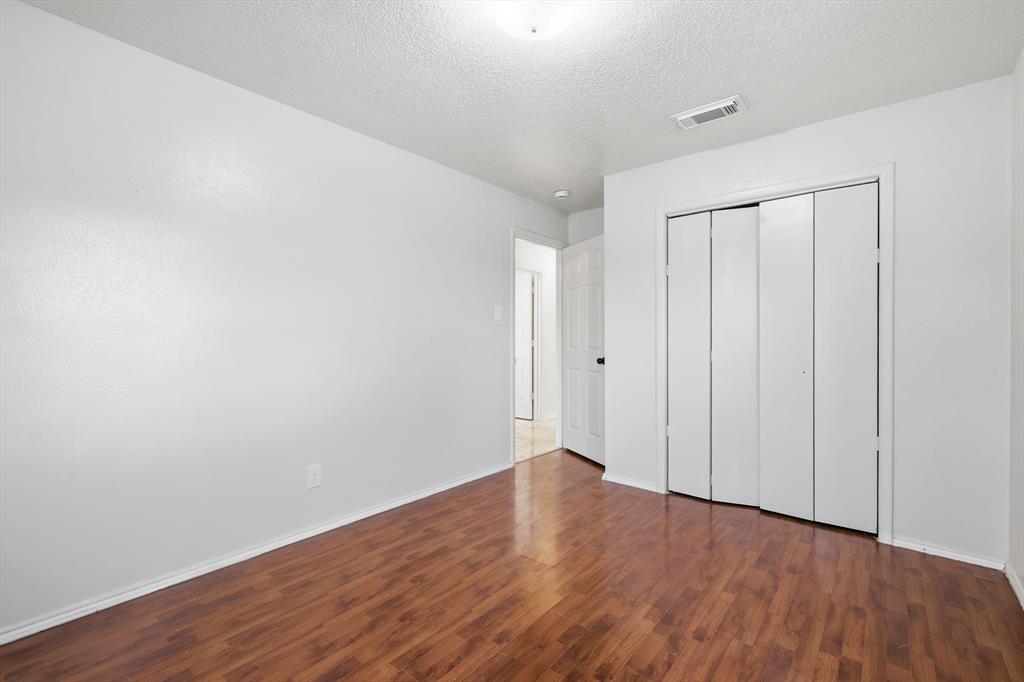 756 East Pecan Street Hurst, TX 76053 - Photo 18 of 19 a view of an empty room with wooden floor
