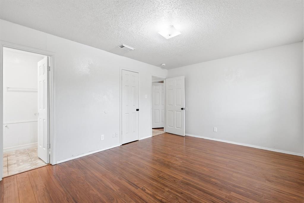 756 East Pecan Street Hurst, TX 76053 - Photo 6 of 19 a view of an empty room with wooden floor