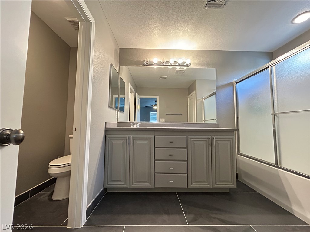 6538 Elm Spring Las Vegas, NV 89148 - Photo 9 of 29 A well-appointed bath features an updated vanity and a glass-enclosed shower.