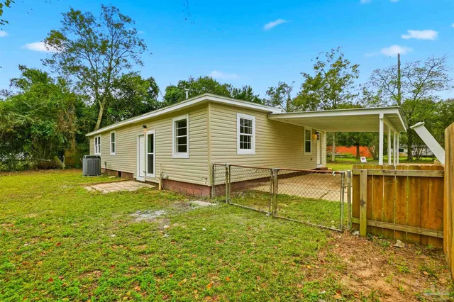 a view of a house with pool and a yard
