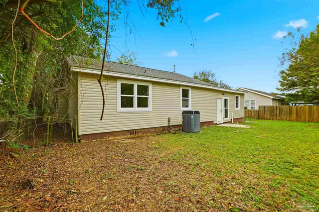 a backyard of a house with table and chairs