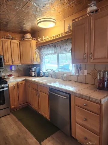 a room with pool table and windows